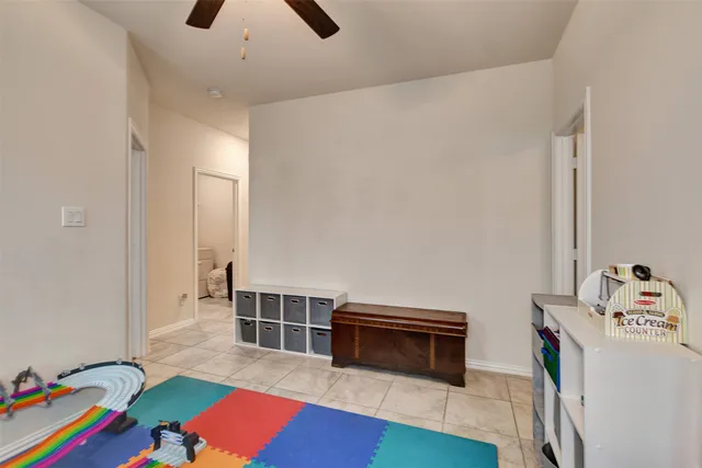 a bedroom with furniture and a book shelf