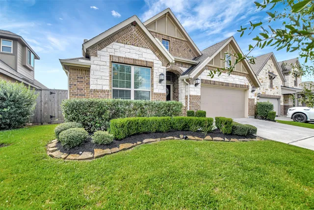 a view of a house with a backyard and a garden