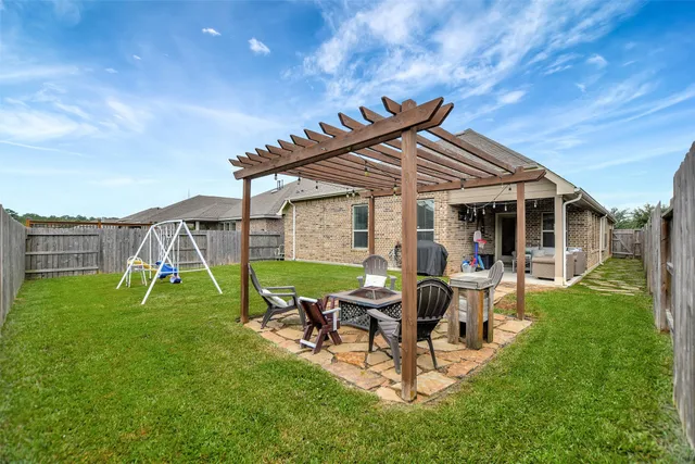 a view of backyard with table and chairs