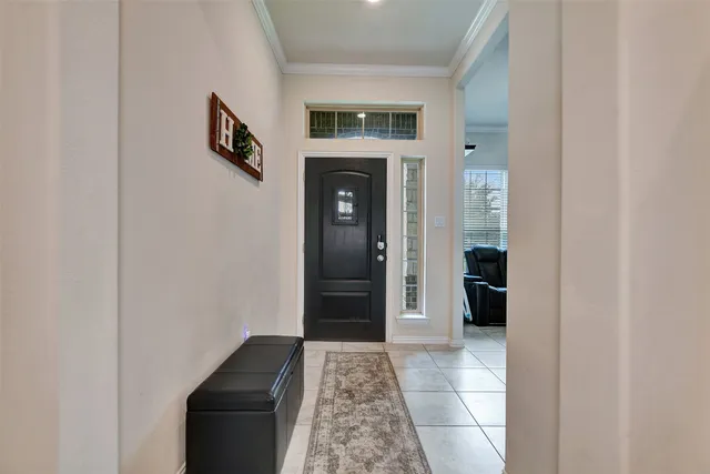 a view of a hallway and a livingroom with a workspace