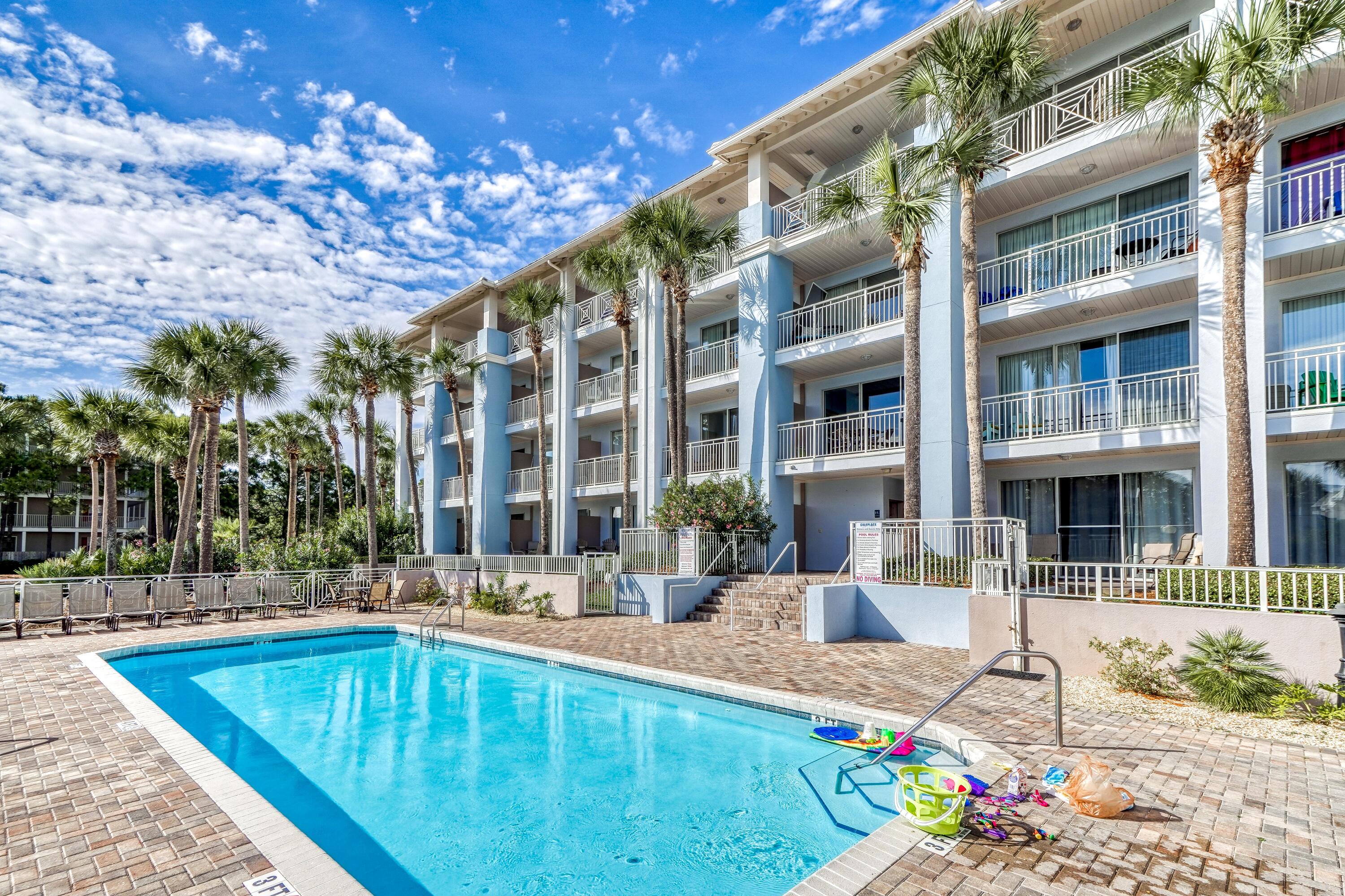 145 Spires Lane, Unit 406 Santa Rosa Beach, FL 32459 - Photo 25 of 38 a swimming pool with outdoor seating and yard