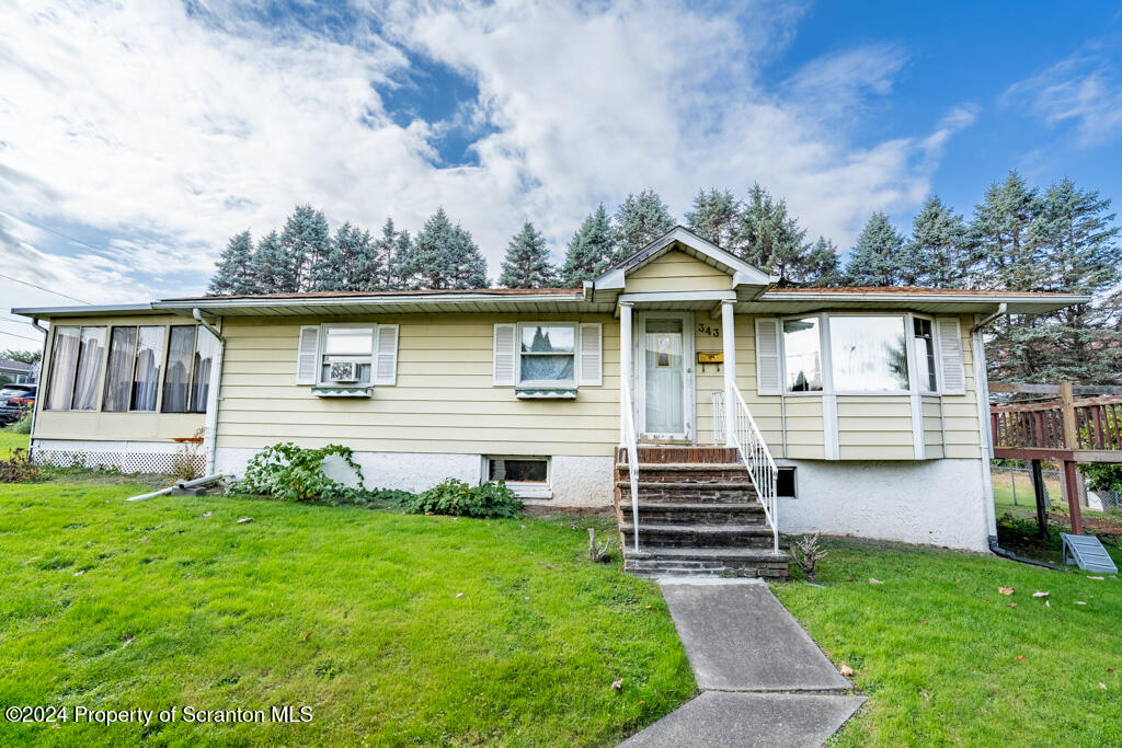 343 Atlantic Street Jessup, PA 18434 - Photo 1 of 19 a front view of a house with garden
