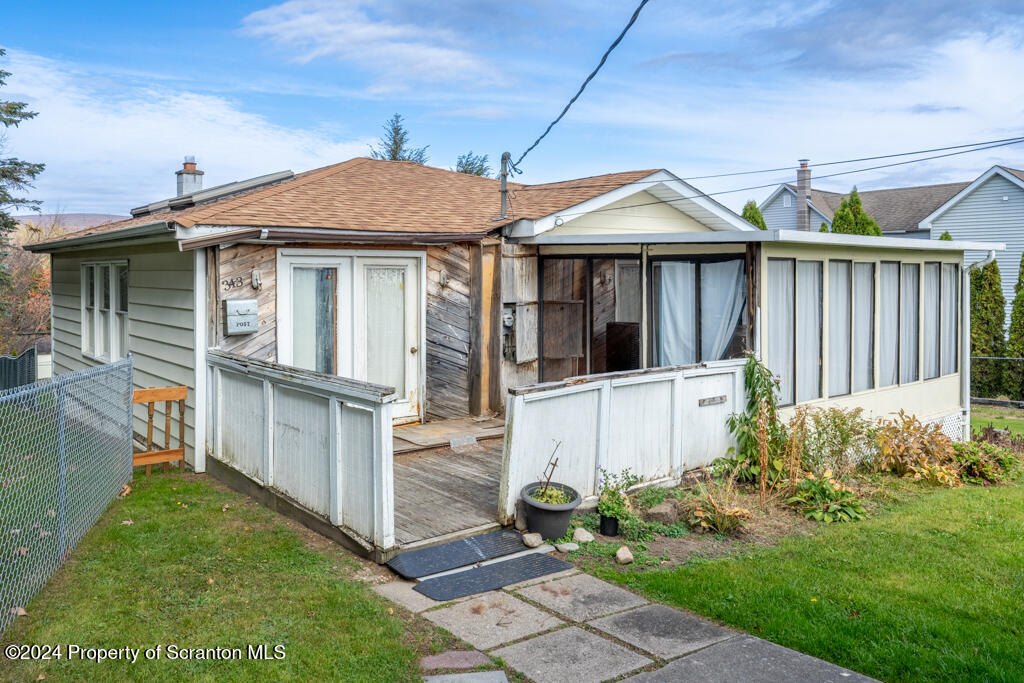 343 Atlantic Street Jessup, PA 18434 - Photo 16 of 19 a view of a white house with a small yard and wooden fence
