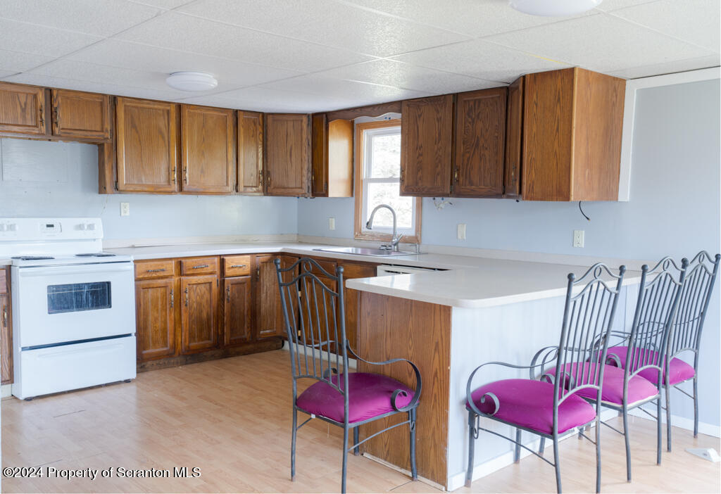 343 Atlantic Street Jessup, PA 18434 - Photo 3 of 19 a kitchen with stainless steel appliances granite countertop a table chairs sink refrigerator and cabinets