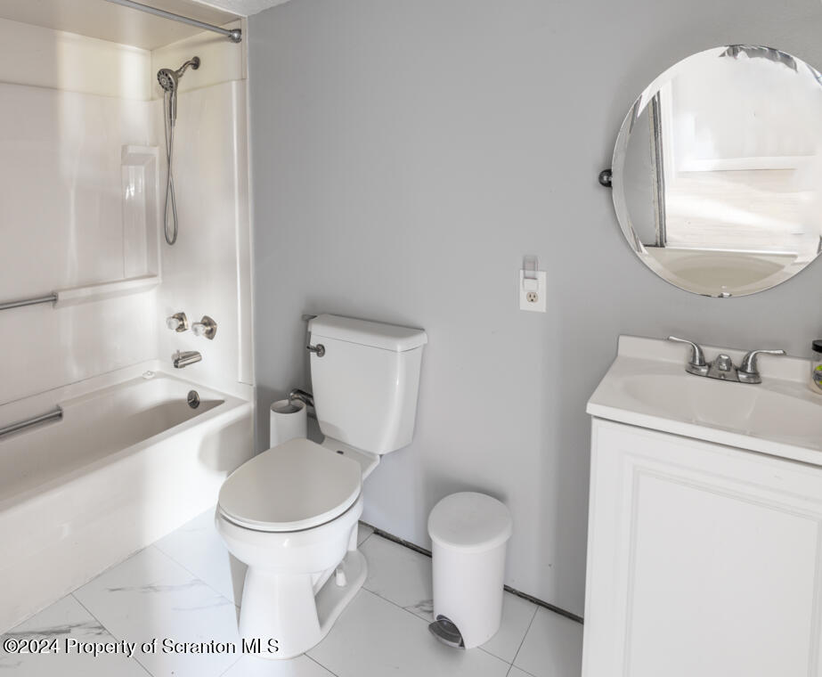 343 Atlantic Street Jessup, PA 18434 - Photo 6 of 19 a white toilet sitting next to a bathroom sink and a tub