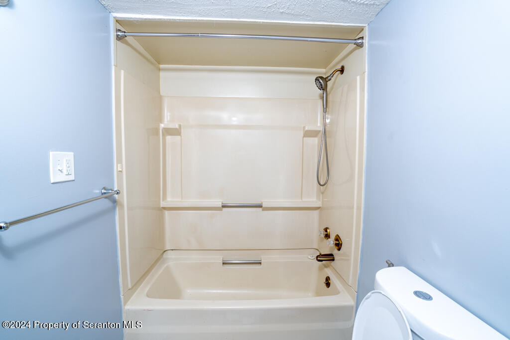 343 Atlantic Street Jessup, PA 18434 - Photo 7 of 19 a bathroom with a bathtub and a shower