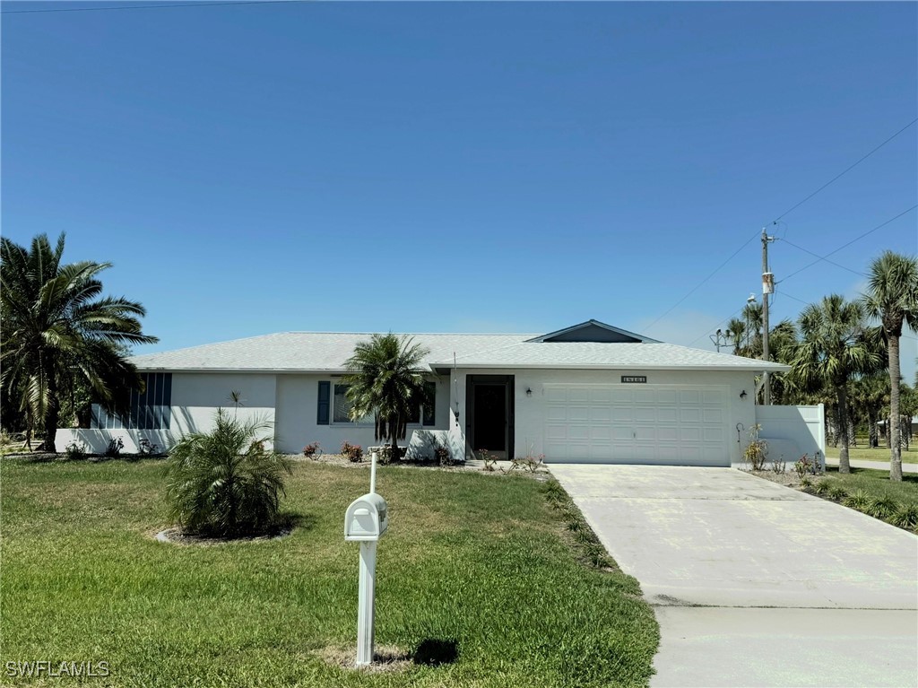 18161 Interlochen Lane Alva, FL 33920 - Photo 1 of 25 a front view of a house with a yard