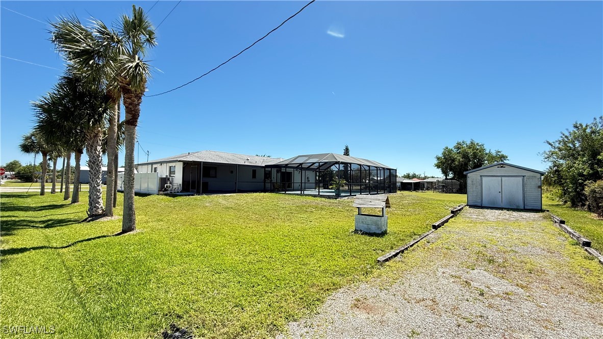18161 Interlochen Lane Alva, FL 33920 - Photo 21 of 25 a swimming pool with some trees in the background