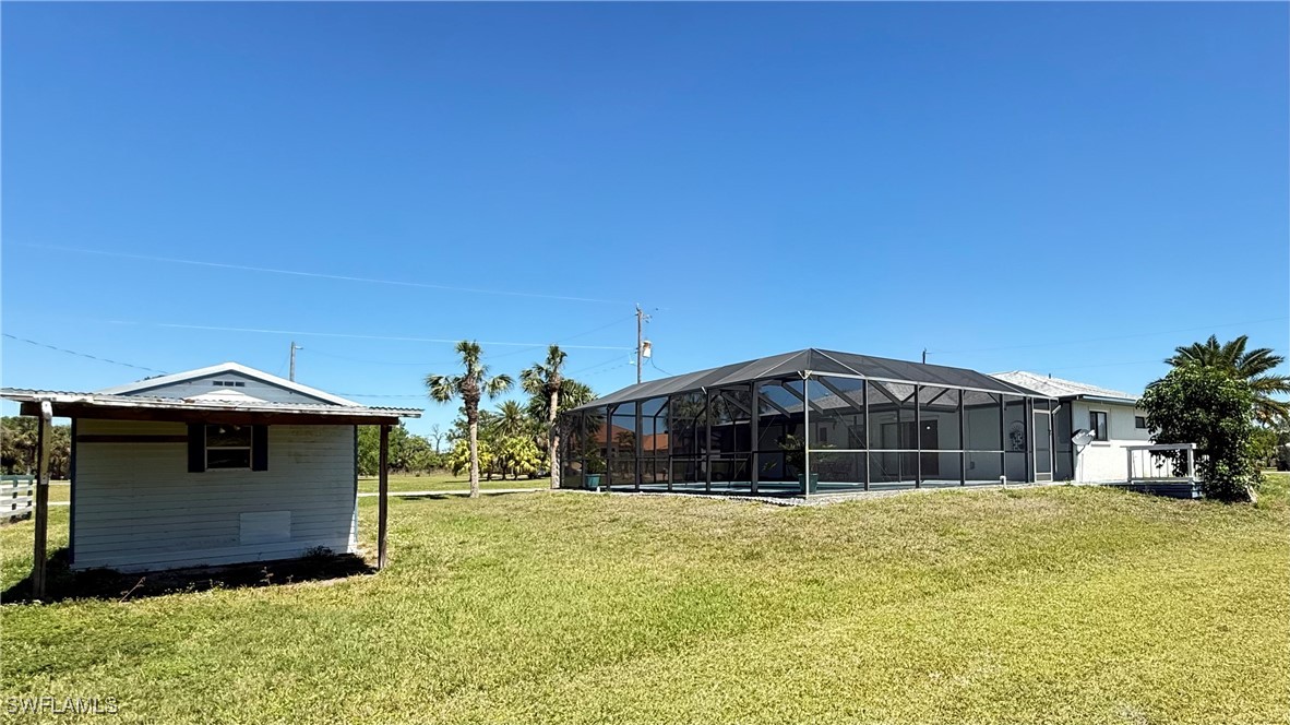 18161 Interlochen Lane Alva, FL 33920 - Photo 22 of 25 a front view of a house with a yard