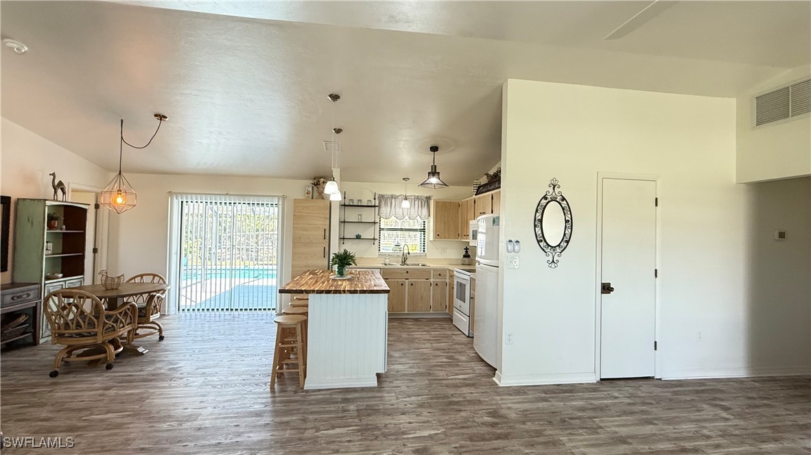 18161 Interlochen Lane Alva, FL 33920 - Photo 4 of 25 a view of kitchen with stainless steel appliances refrigerator oven stove dining table and chairs