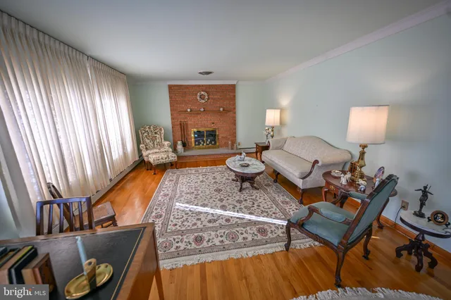 a living room with furniture a rug and a lamp
