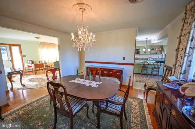 a view of a dining room with furniture wooden floor and chandelier