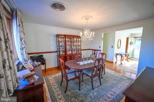 a view of a dining room with furniture and chandelier