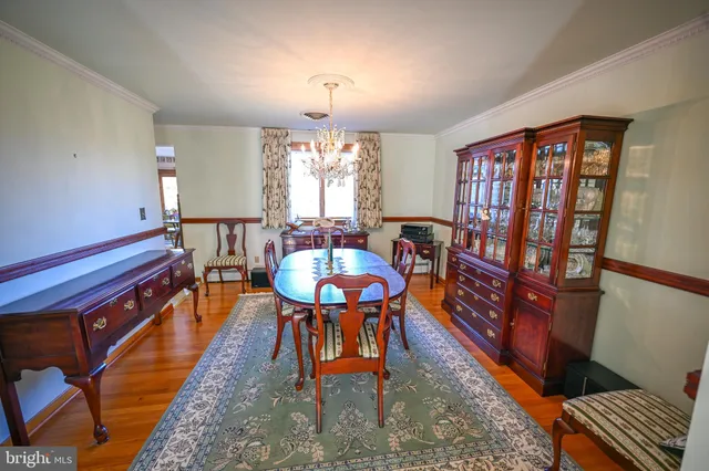 a dining room with furniture and chandelier