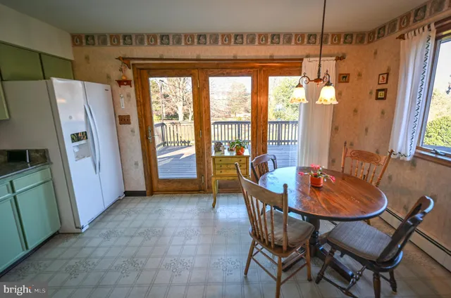 a dining room with furniture a chandelier and wooden floor