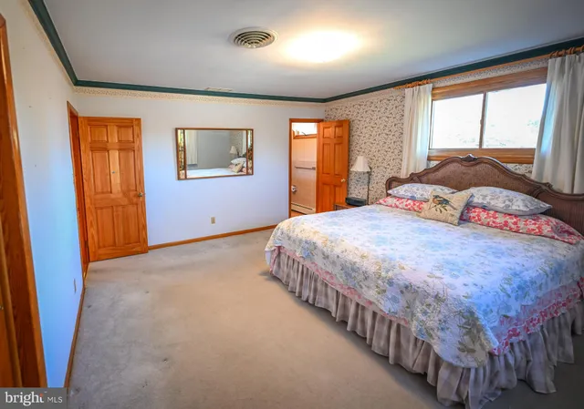 a bedroom with a large bed and a window