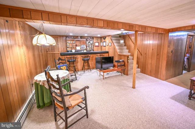 a spacious bedroom with a bed and wooden floor