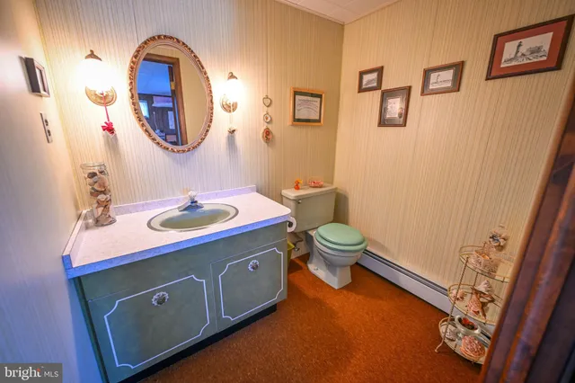 a view of a room with lots of furniture and a chandelier