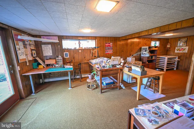 a bedroom with furniture and a large window