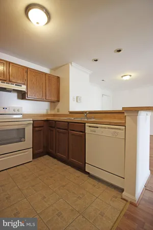 a kitchen with a stove sink and cabinets