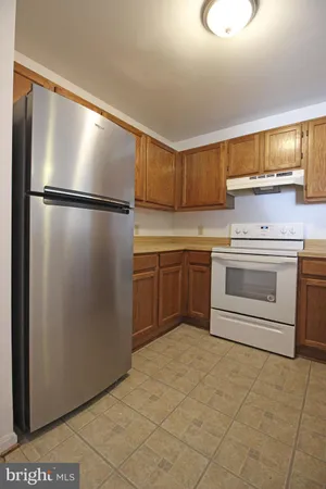 a kitchen with a sink stainless steel appliances and cabinets