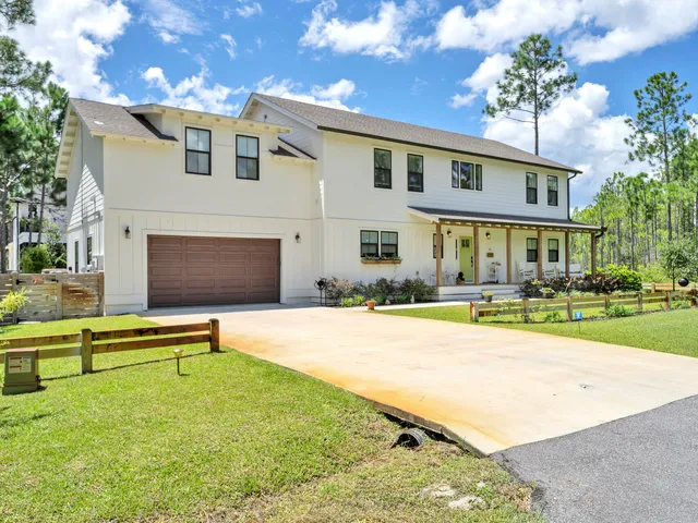 a view of a house with backyard porch and sitting area