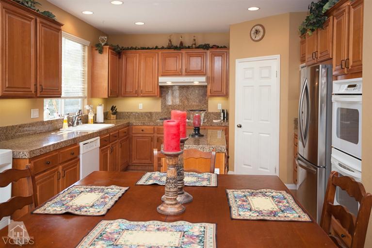 14396 Peach Hill Road Moorpark, CA 93021 - Photo 12 of 45 a kitchen with a sink stove and refrigerator