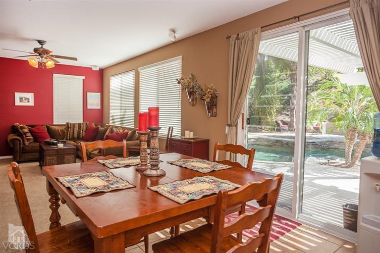 14396 Peach Hill Road Moorpark, CA 93021 - Photo 13 of 45 a view of a dining room with furniture large windows and wooden floor