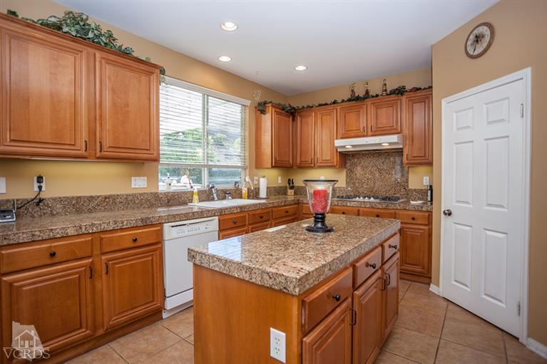 14396 Peach Hill Road Moorpark, CA 93021 - Photo 14 of 45 a kitchen with granite countertop cabinets stainless steel appliances a sink and a window
