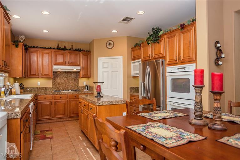 14396 Peach Hill Road Moorpark, CA 93021 - Photo 16 of 45 a kitchen with stainless steel appliances granite countertop a sink stove and refrigerator