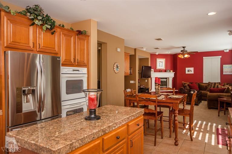 14396 Peach Hill Road Moorpark, CA 93021 - Photo 17 of 45 a kitchen with stainless steel appliances granite countertop a refrigerator a stove and a sink