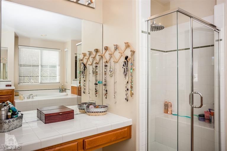 14396 Peach Hill Road Moorpark, CA 93021 - Photo 27 of 45 a bathroom with a granite countertop sink and a shower