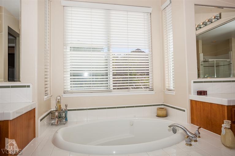 14396 Peach Hill Road Moorpark, CA 93021 - Photo 28 of 45 a bathroom with bathtub and window