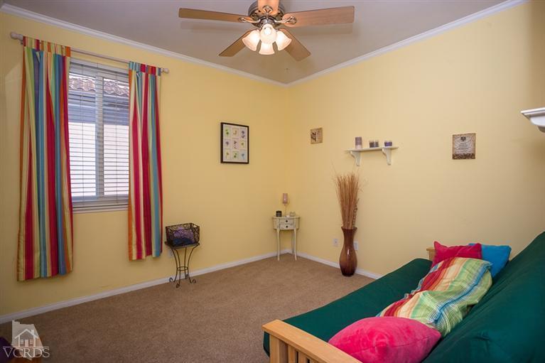 14396 Peach Hill Road Moorpark, CA 93021 - Photo 29 of 45 a bedroom with a bed and a chandelier