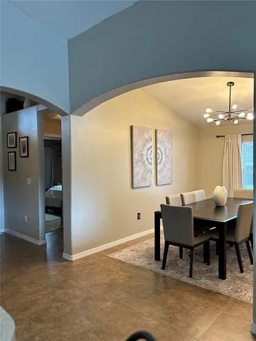 a view of a dining room with furniture and chandelier