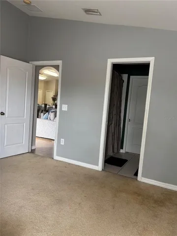 an empty room with closet and a fireplace