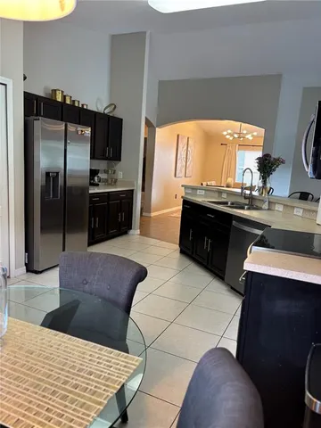 a kitchen with a refrigerator and a stove