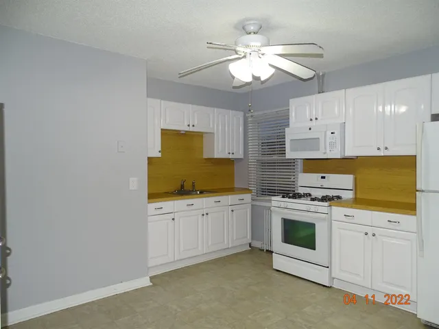 a kitchen with stainless steel appliances granite countertop a stove sink and cabinets