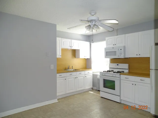 a kitchen with stainless steel appliances granite countertop a stove sink and cabinets