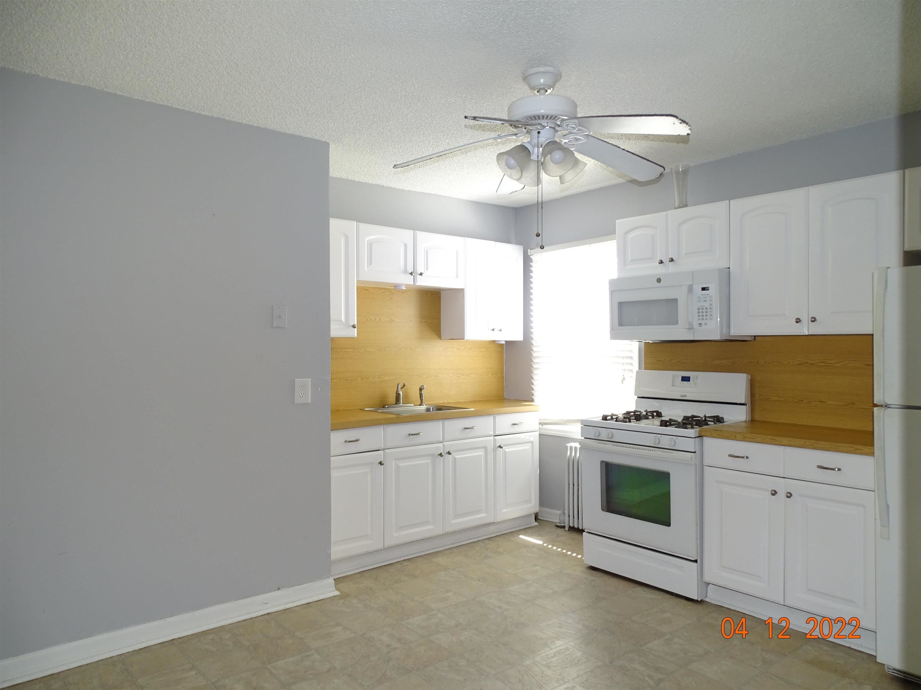 124 West 8th Street, Unit 2 Bayonne, NJ 07002 - Photo 16 of 19 a kitchen with stainless steel appliances granite countertop a stove sink and cabinets