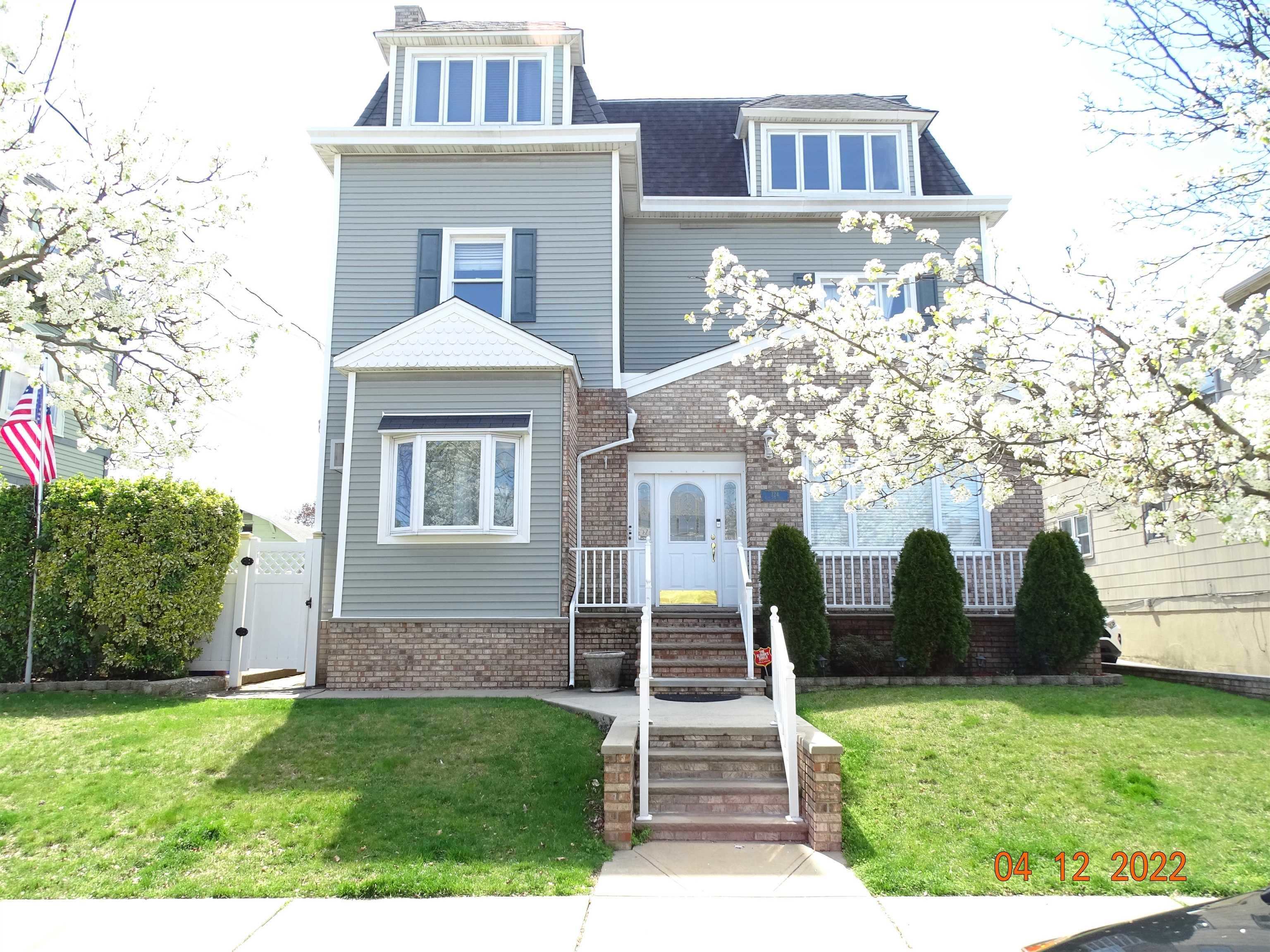 124 West 8th Street, Unit 2 Bayonne, NJ 07002 - Photo 2 of 19 a front view of a house with garden