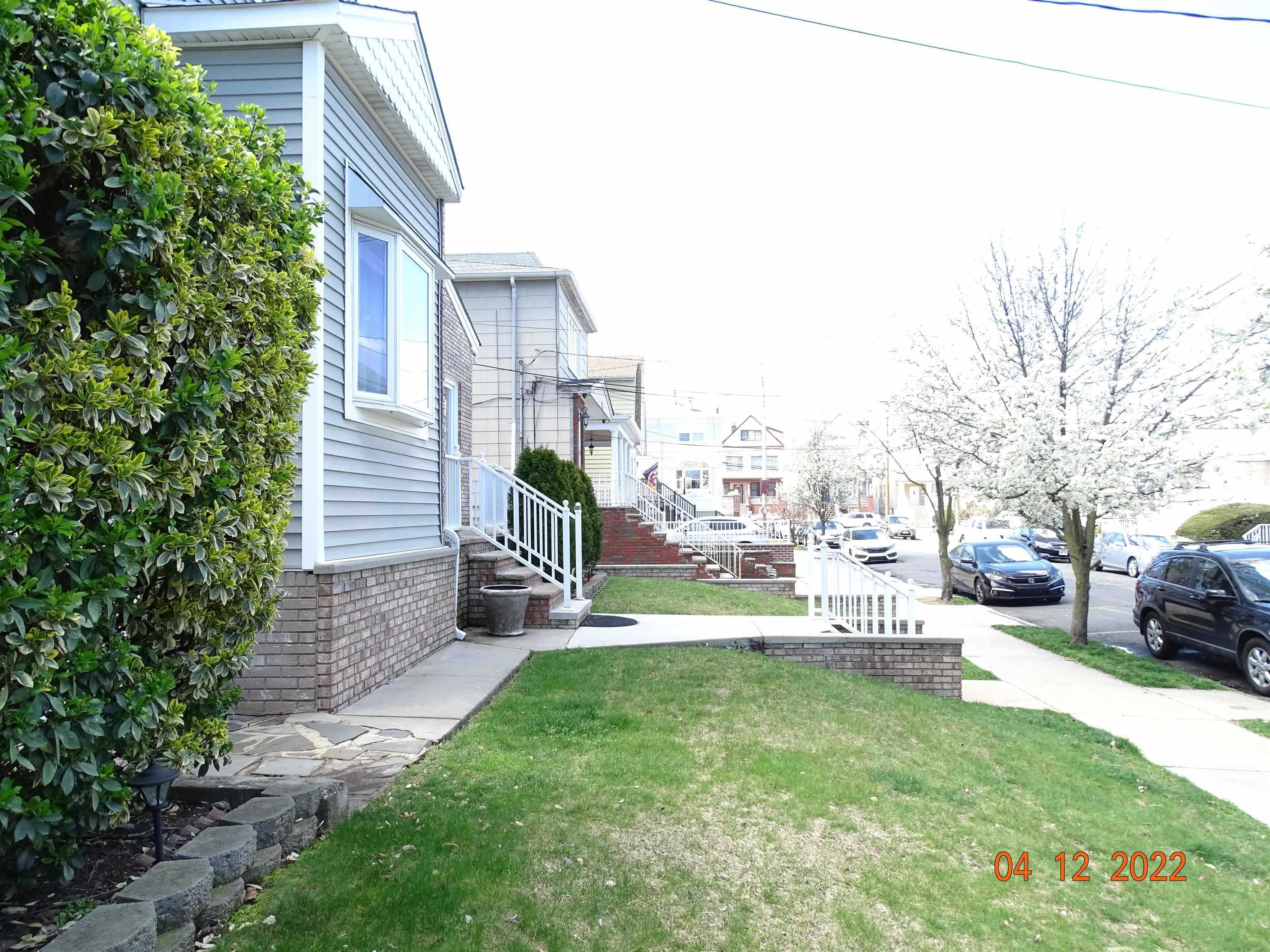 124 West 8th Street, Unit 2 Bayonne, NJ 07002 - Photo 3 of 19 a view of a building with a yard and sitting area