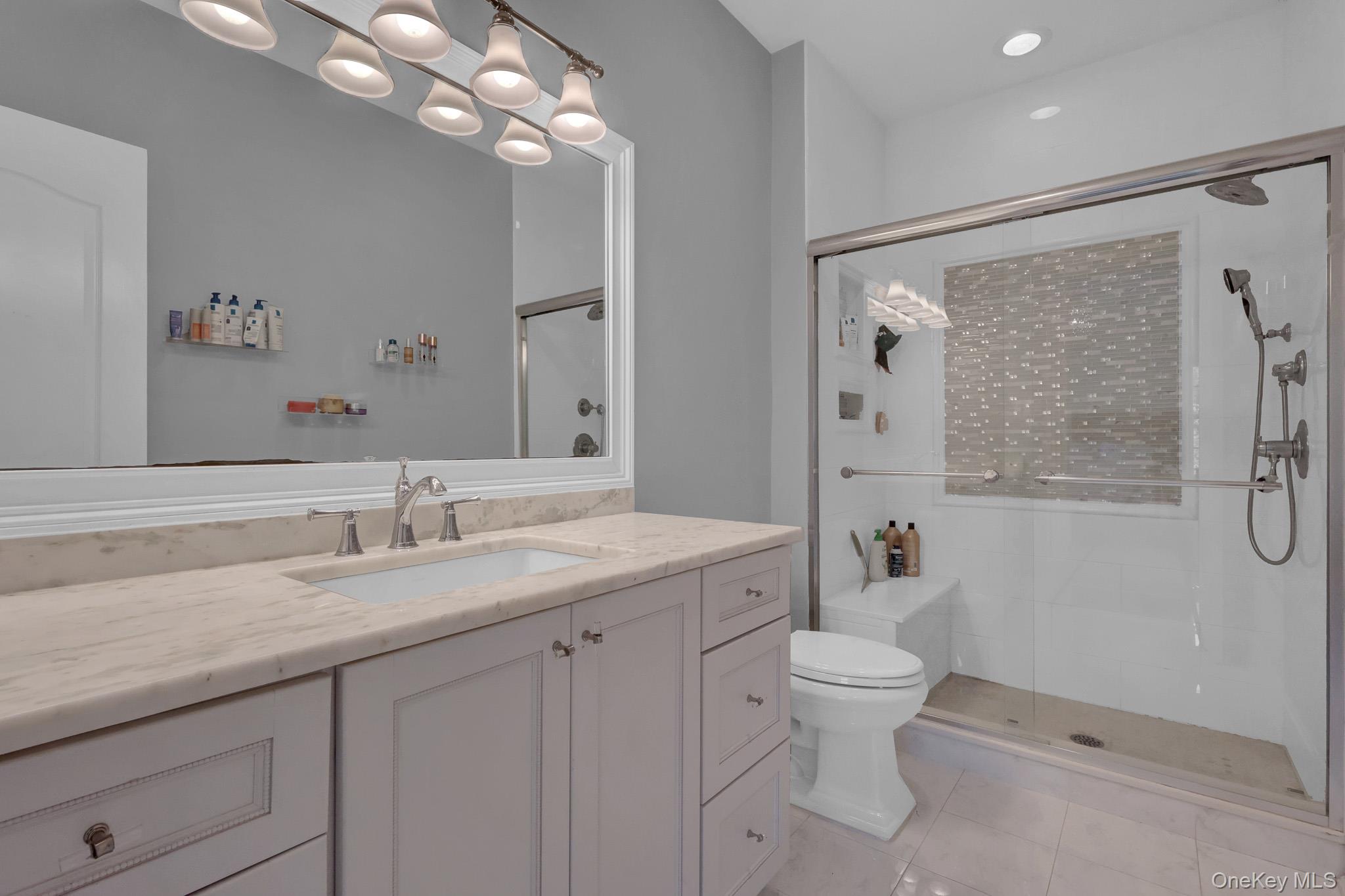 36 Old Field Road Setauket, NY 11733 - Photo 40 of 42 a bathroom with a granite countertop sink a toilet and a mirror