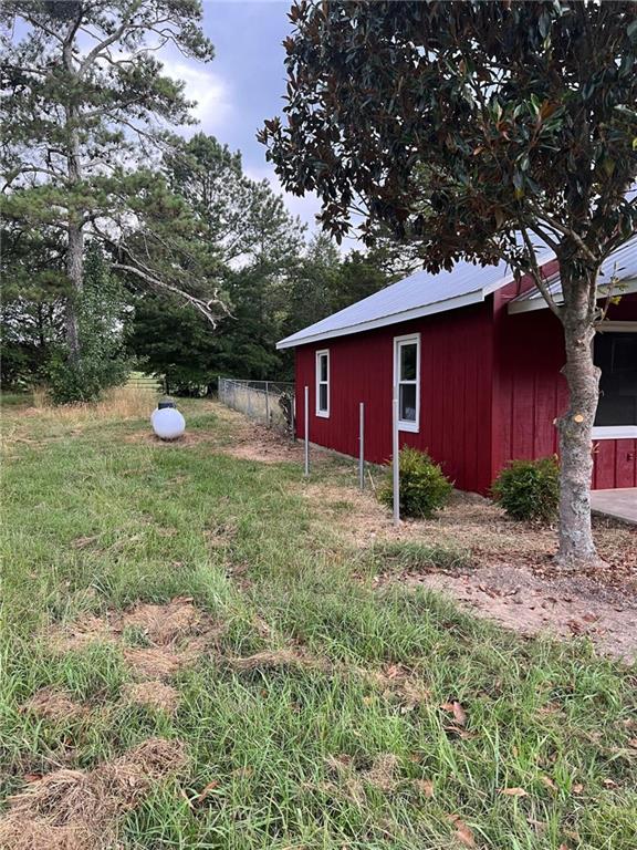 91 Davis Loop Kingston, GA 30145 - Photo 2 of 24 a fire hydrant in the middle of a field