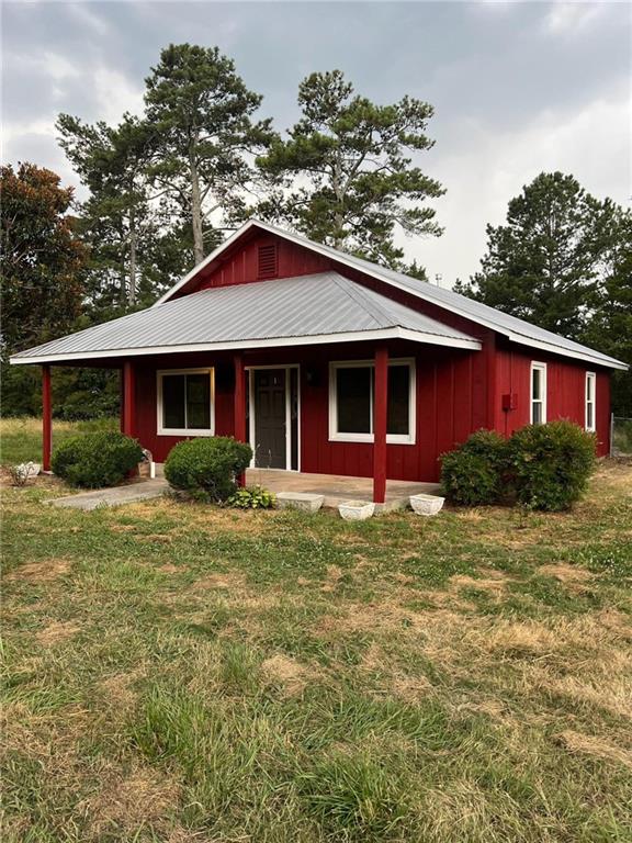 91 Davis Loop Kingston, GA 30145 - Photo 3 of 24 a front view of a house with a yard