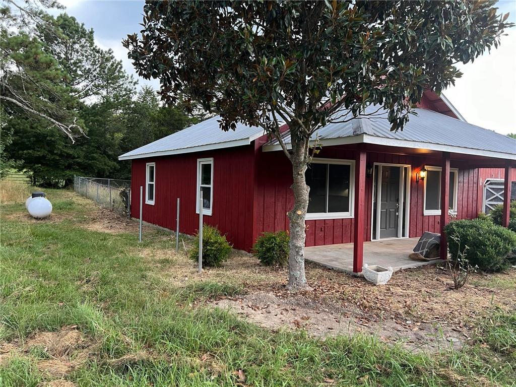 91 Davis Loop Kingston, GA 30145 - Photo 4 of 24 a front view of a house with garden