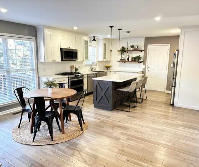 400 Roma Court Nashville, TN 37211 - Photo 13 of 31 a dining room with kitchen island granite countertop a table chairs and a microwave