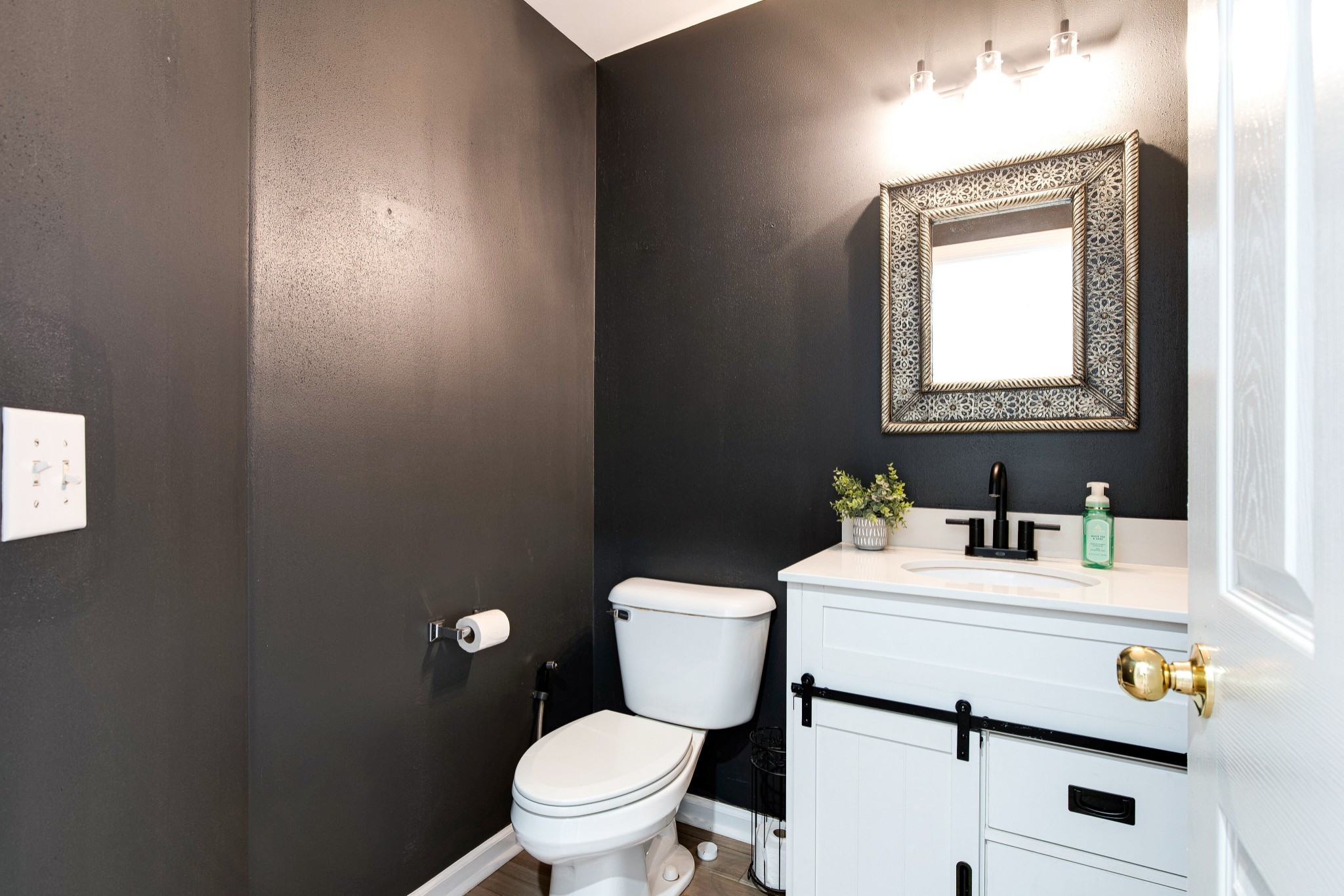 400 Roma Court Nashville, TN 37211 - Photo 22 of 31 a bathroom with a sink a toilet and a mirror