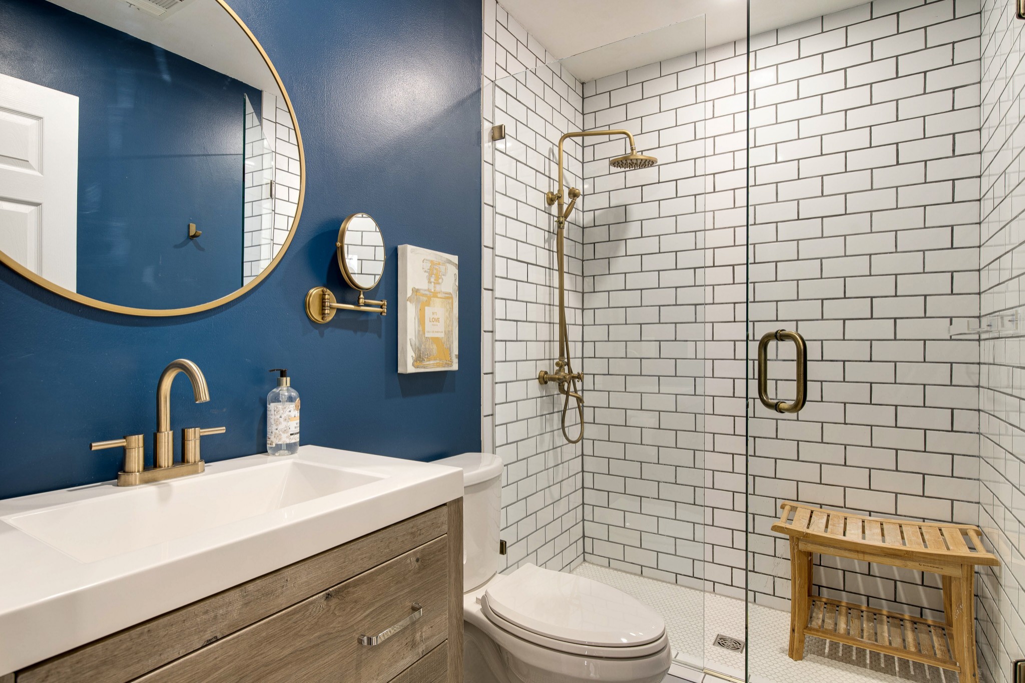 400 Roma Court Nashville, TN 37211 - Photo 25 of 31 a bathroom with a toilet a sink a mirror and shower
