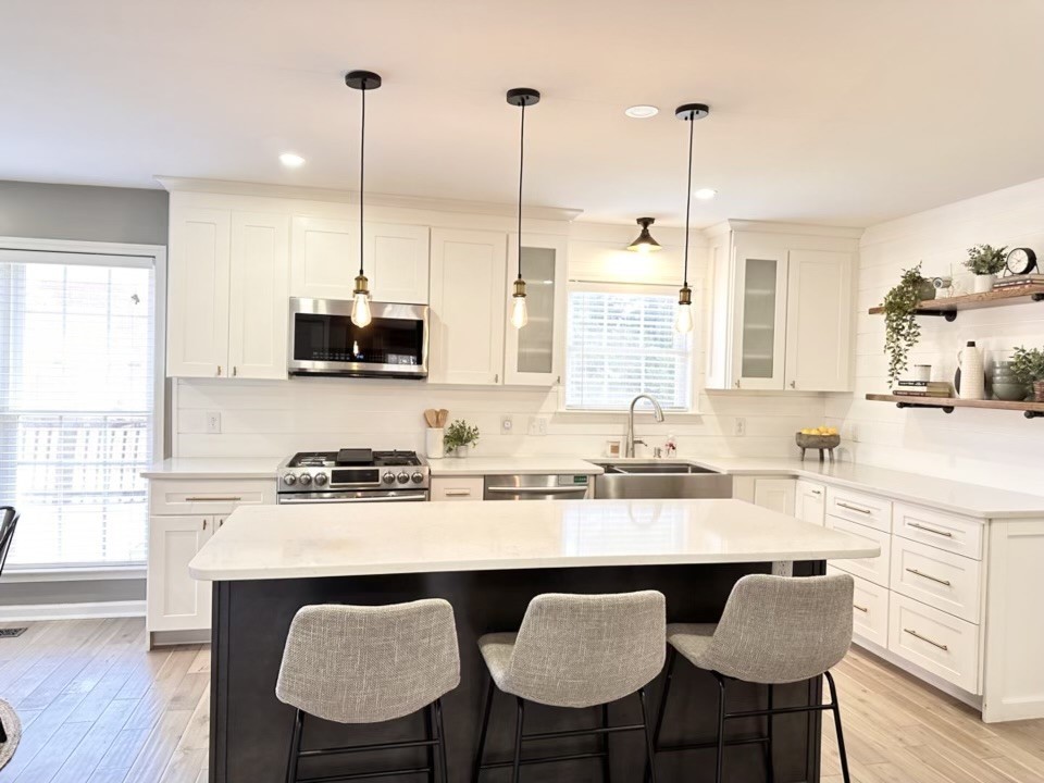 400 Roma Court Nashville, TN 37211 - Photo 8 of 31 a kitchen with stainless steel appliances granite countertop a stove a sink dishwasher a microwave oven with white cabinets and wooden floor